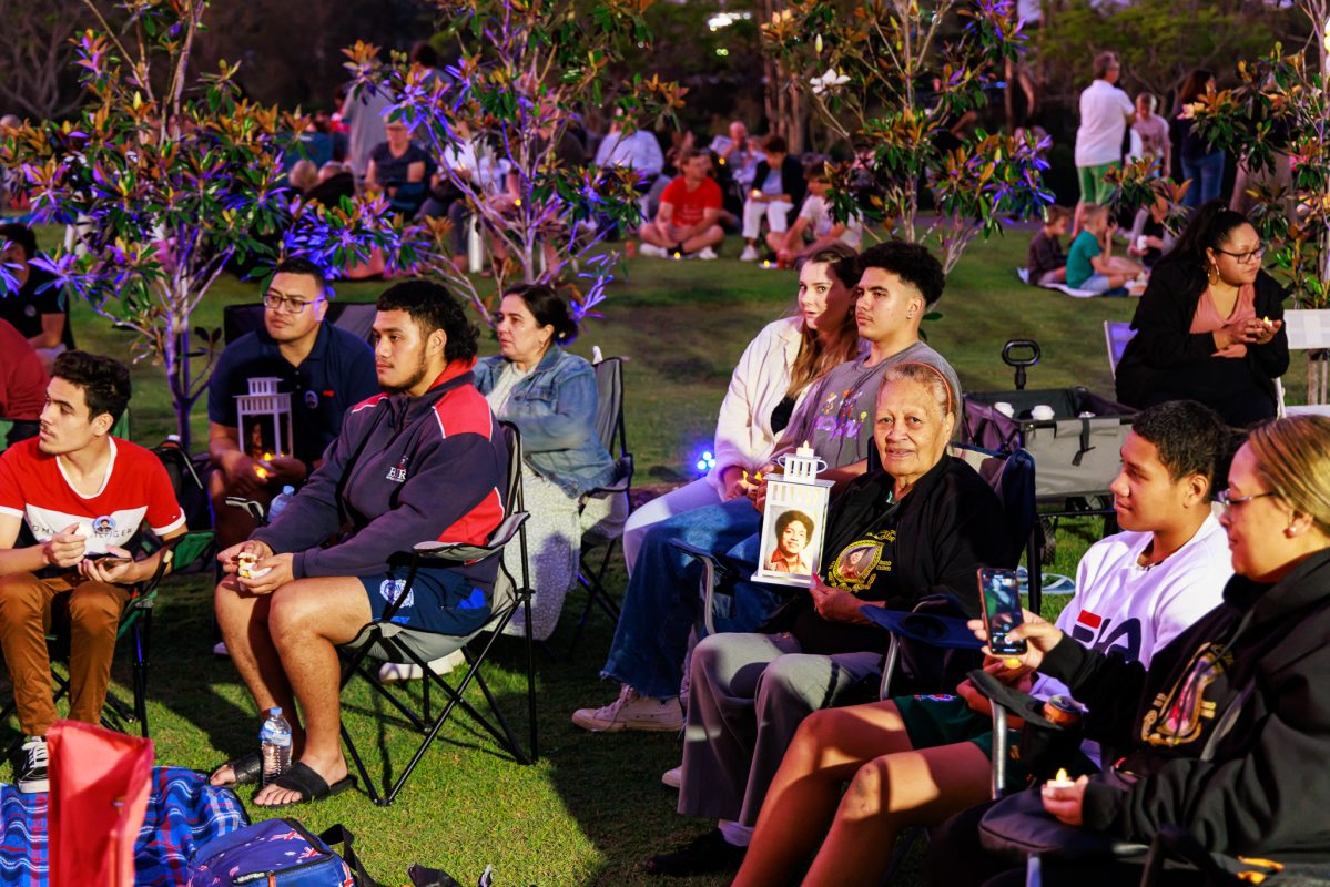 Families and guests of Centenary Memorial Gardens sitting in chairs covering the grassed area outside Centenary Memorial Gardens main Admin Area. They are enjoying the Christmas Carols at the 2022 Christmas Event.