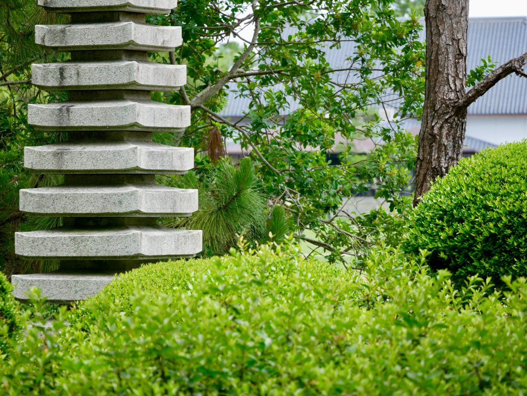 Partial view of a Japanese garden sculpture and surrounding gardens, indicative of the gardens which may surround the new lotus gardens at Centenary Memorial Gardens Cemetery and Crematorium.